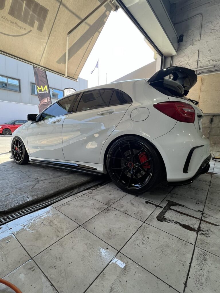 Λευκό hatchback μετά από επαγγελματικό καθαρισμό και περιποίηση στο NK Car Wash.